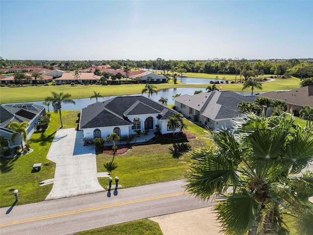 drone / aerial view featuring a residential view and a water view