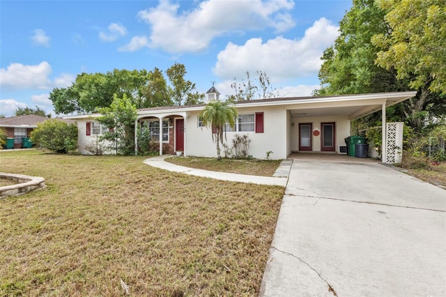 single story home featuring an attached carport, concrete driveway, a front yard, and stucco siding