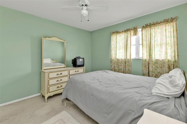 bedroom with baseboards, light carpet, and ceiling fan