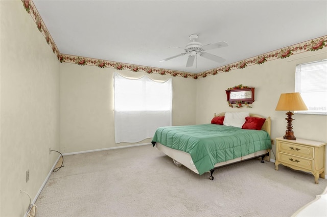 bedroom featuring light carpet, ceiling fan, and baseboards