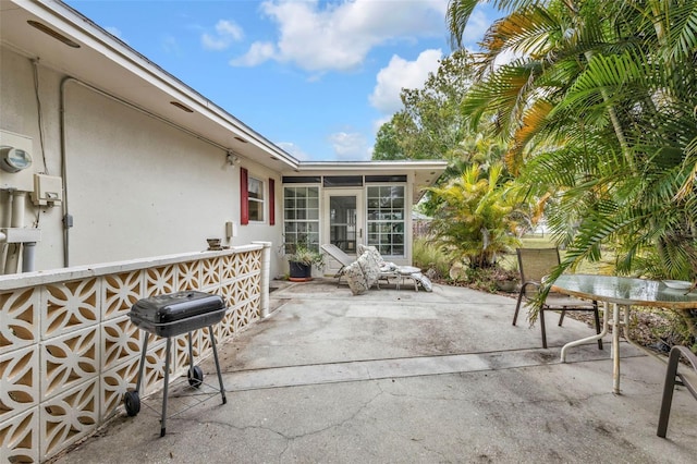 view of patio featuring area for grilling and a sunroom