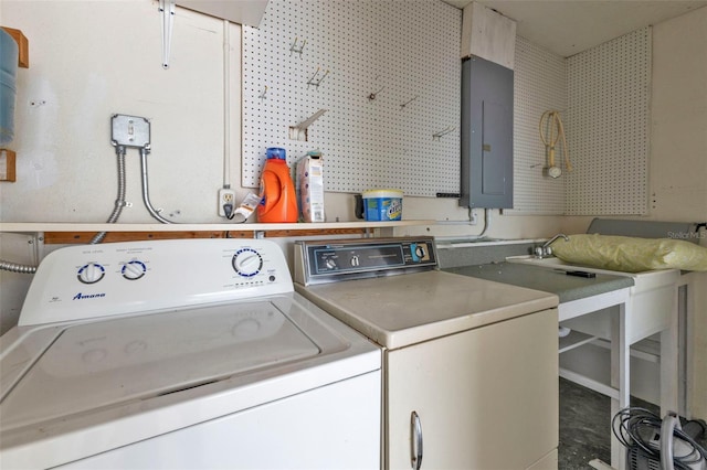 clothes washing area with a workshop area, electric panel, and independent washer and dryer