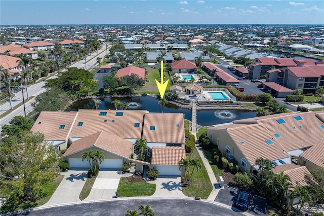 birds eye view of property with a residential view and a water view