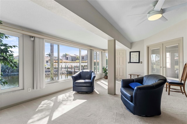 sitting room featuring carpet floors, french doors, lofted ceiling, a ceiling fan, and baseboards