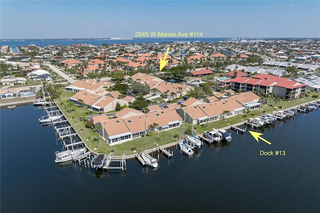 drone / aerial view with a water view and a residential view