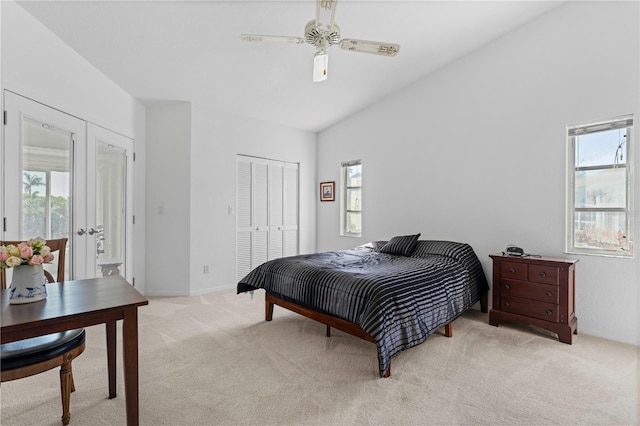 bedroom with french doors, lofted ceiling, a closet, light colored carpet, and ceiling fan