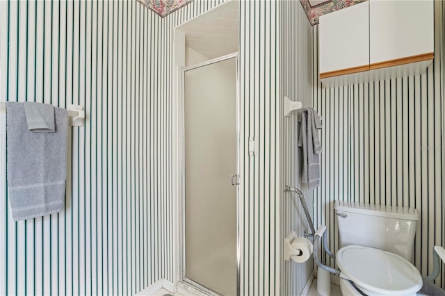 bathroom with toilet and a shower stall