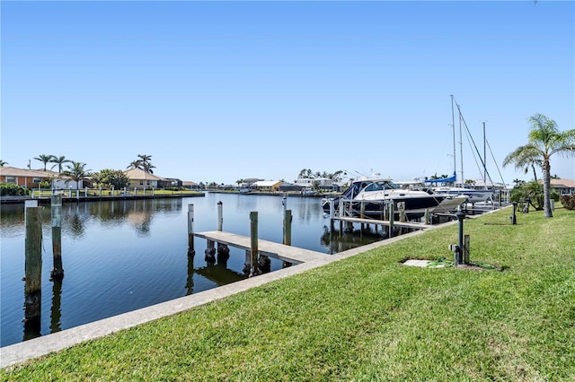 view of dock with a yard, a water view, and a residential view