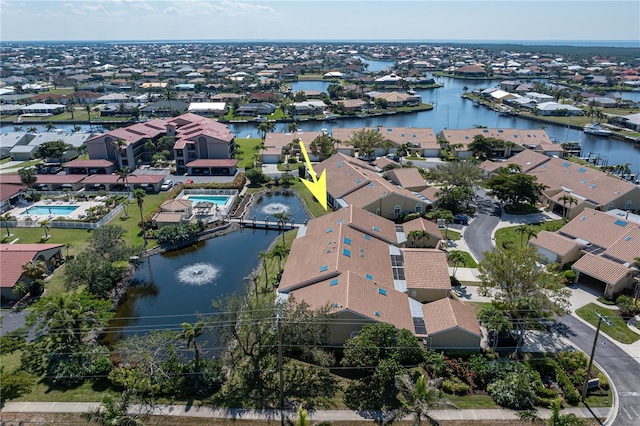 drone / aerial view with a residential view and a water view