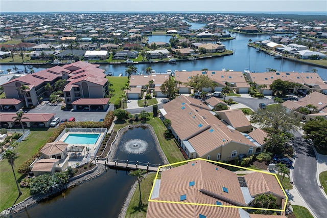 drone / aerial view featuring a water view and a residential view