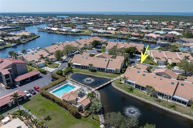 drone / aerial view with a water view and a residential view