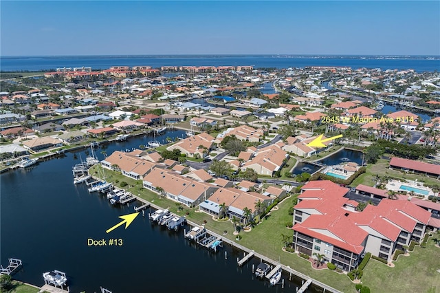 drone / aerial view with a water view and a residential view