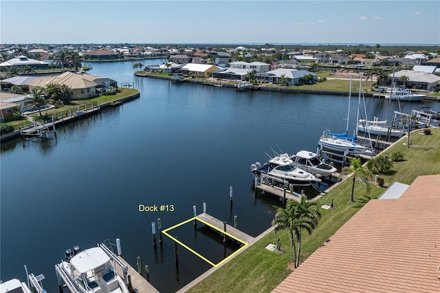 birds eye view of property featuring a water view and a residential view