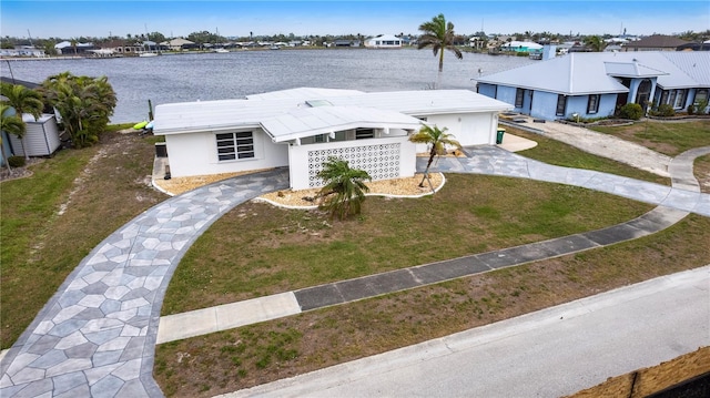 birds eye view of property featuring a water view and a residential view