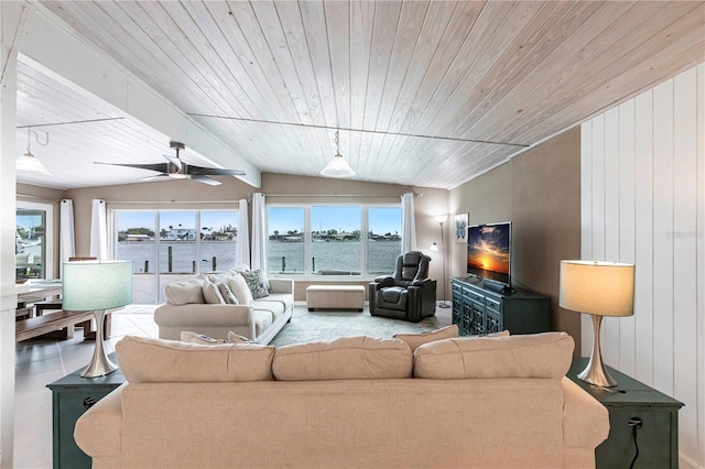 living area featuring a wealth of natural light, wooden ceiling, ceiling fan, and vaulted ceiling