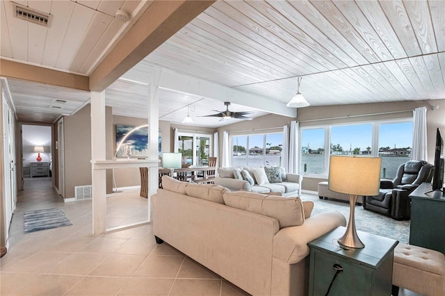 living area featuring wooden ceiling, light tile patterned floors, baseboards, and visible vents