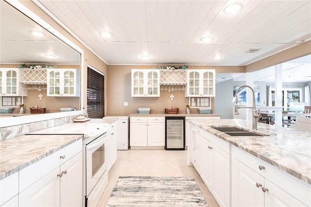 kitchen featuring light tile patterned floors, a sink, wine cooler, glass insert cabinets, and white range with electric stovetop