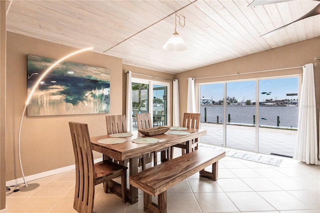 dining room with baseboards, a water view, wood ceiling, lofted ceiling, and light tile patterned floors