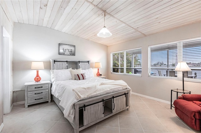 bedroom featuring light tile patterned floors, baseboards, wood ceiling, and lofted ceiling