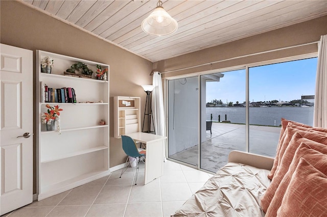 interior space featuring light tile patterned floors, wood ceiling, a water view, and baseboards