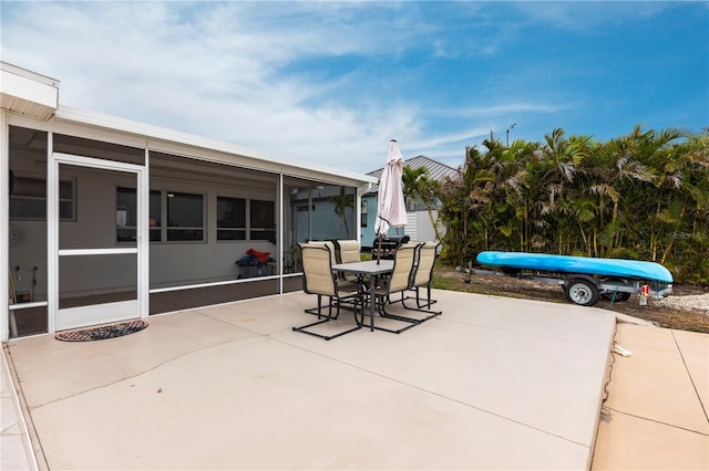 view of patio / terrace with outdoor dining area and a sunroom