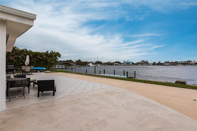 view of patio featuring a dock and a water view