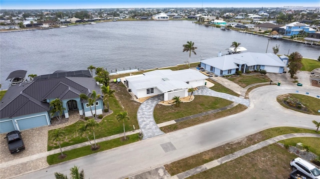 drone / aerial view featuring a residential view and a water view