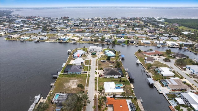 drone / aerial view featuring a water view and a residential view