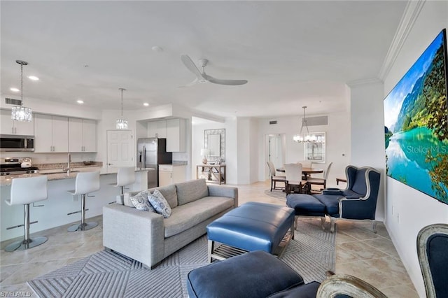 living room with crown molding, recessed lighting, ceiling fan with notable chandelier, and visible vents