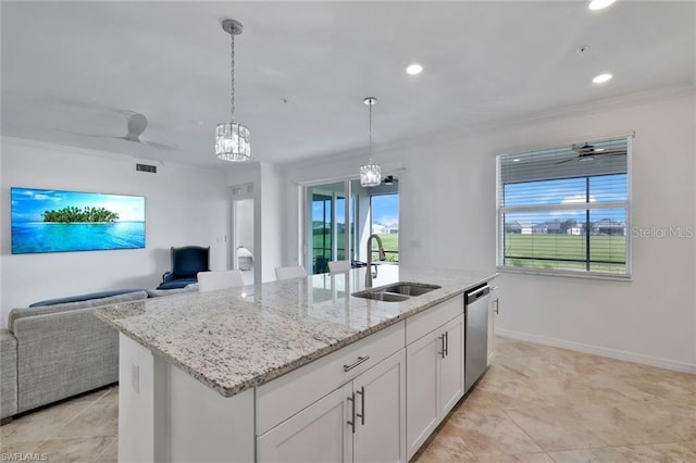 kitchen with a center island with sink, a sink, decorative light fixtures, stainless steel dishwasher, and open floor plan