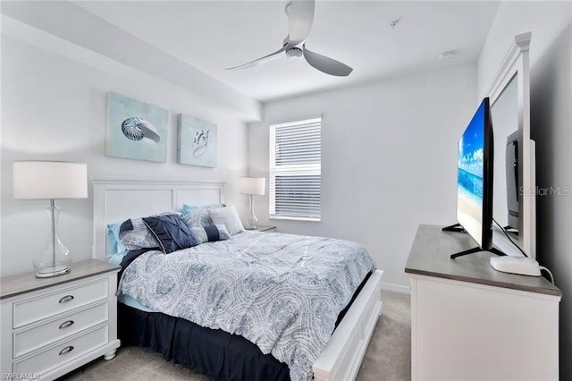 bedroom featuring baseboards, light carpet, and a ceiling fan