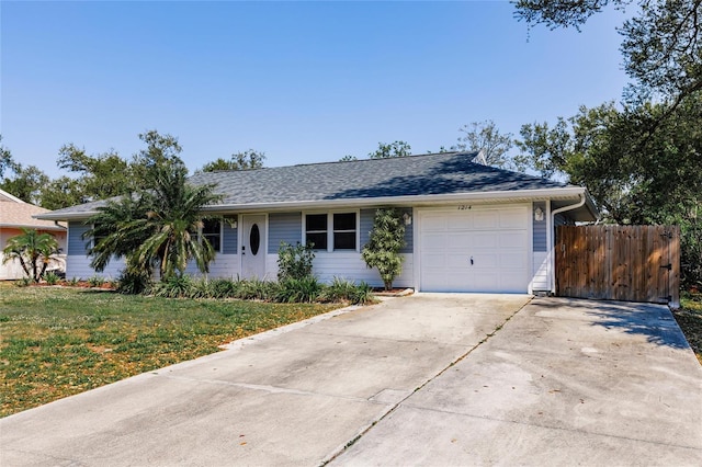 single story home featuring a shingled roof, a front lawn, fence, a garage, and driveway