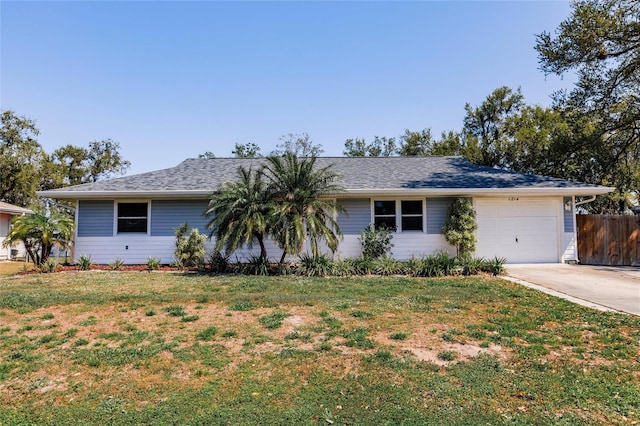 ranch-style house featuring an attached garage, driveway, a front lawn, and fence