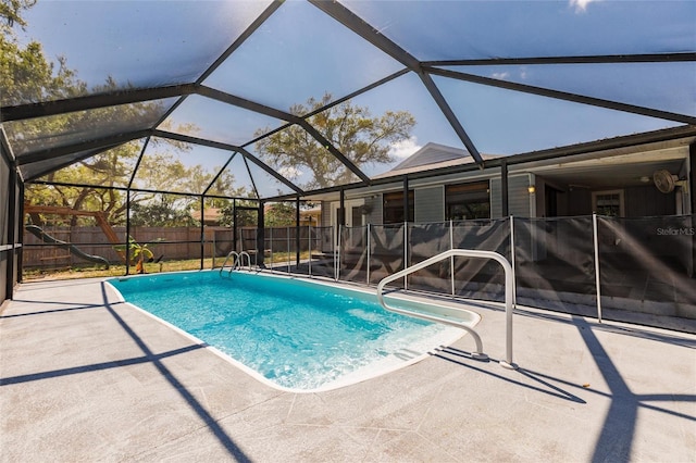 view of pool with a patio area, a fenced backyard, a fenced in pool, and a lanai