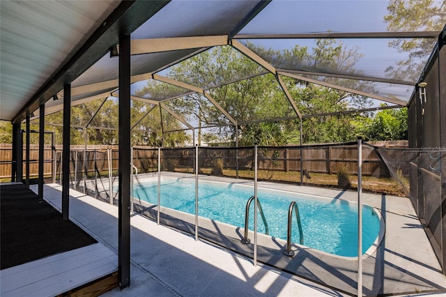 view of swimming pool featuring a patio area, a fenced in pool, a lanai, and a fenced backyard