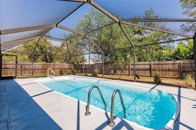 view of swimming pool with a lanai, a fenced in pool, a fenced backyard, and a patio area