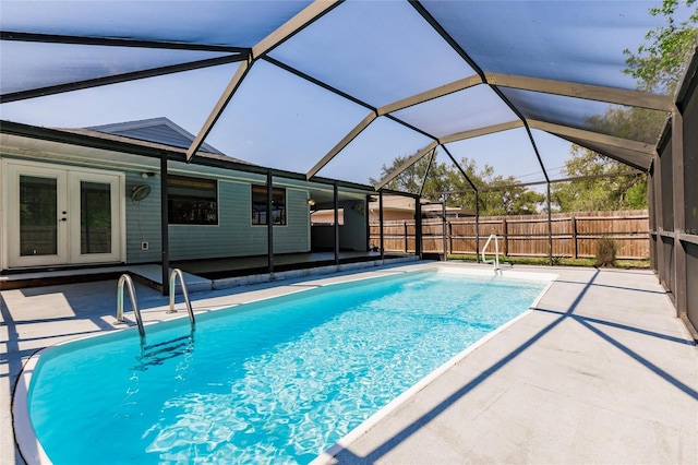 view of swimming pool with french doors, a patio, and fence