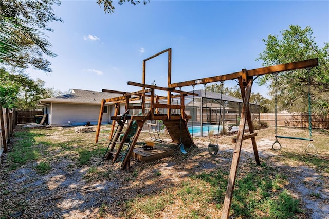 view of playground featuring glass enclosure, a fenced backyard, and a fenced in pool