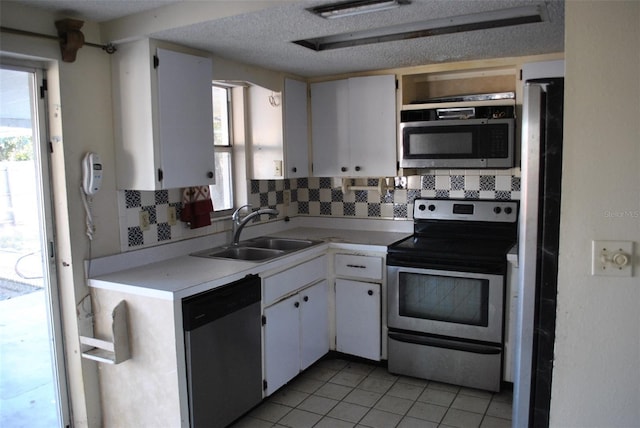 kitchen featuring plenty of natural light, stainless steel appliances, a sink, and light countertops