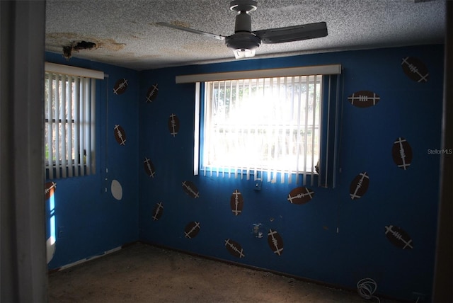 interior space featuring ceiling fan and a textured ceiling