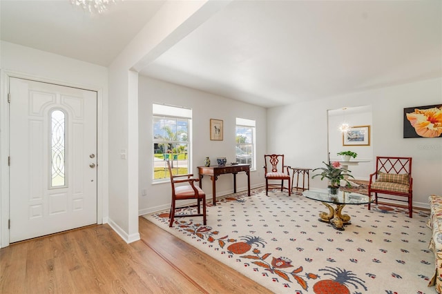 foyer entrance with light wood-style flooring and baseboards