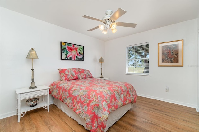 bedroom with wood finished floors, baseboards, and ceiling fan