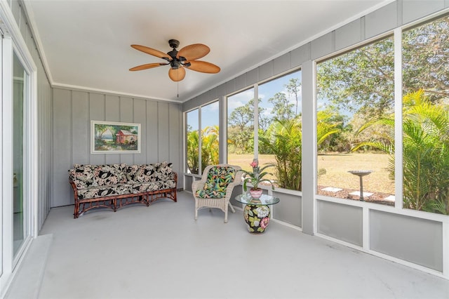 sunroom / solarium featuring ceiling fan