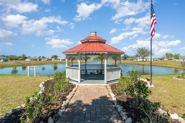 dock area featuring a gazebo, a lawn, and a water view