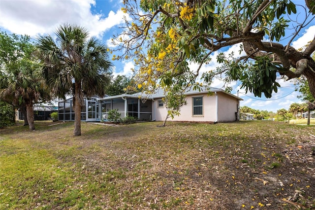 3436 Discovery Dr, Punta Gorda, FL 33983 - back of house with a lawn, a sunroom, and stucco siding