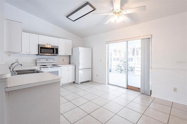 3436 Discovery Dr, Punta Gorda, FL 33983 - kitchen featuring a sink, vaulted ceiling, white appliances, light countertops, and light tile patterned floors