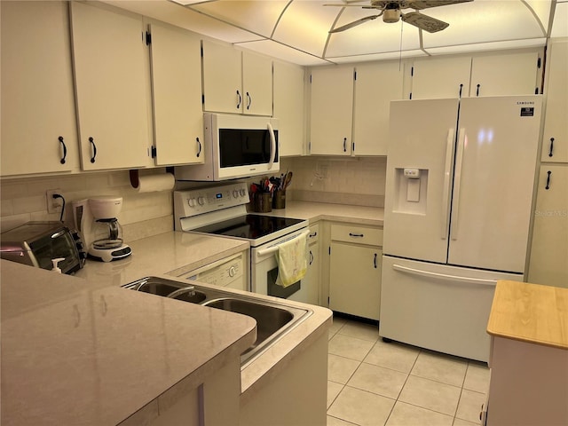 kitchen with white appliances, light tile patterned flooring, a ceiling fan, and light countertops