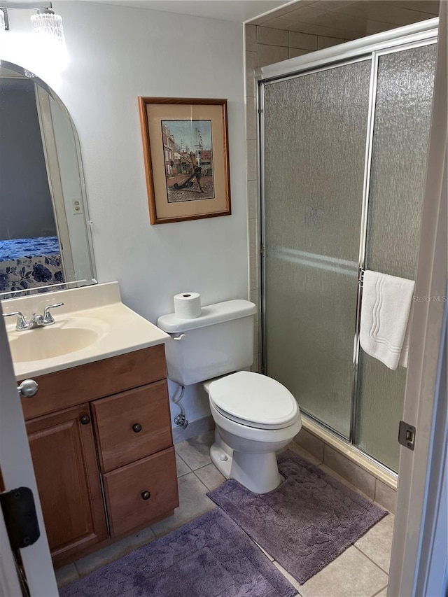 full bath with tile patterned floors, a shower stall, toilet, and vanity