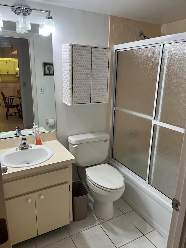 full bath featuring vanity, tile patterned floors, toilet, and enclosed tub / shower combo