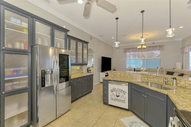 kitchen with ornamental molding, light tile patterned floors, light stone counters, appliances with stainless steel finishes, and a sink